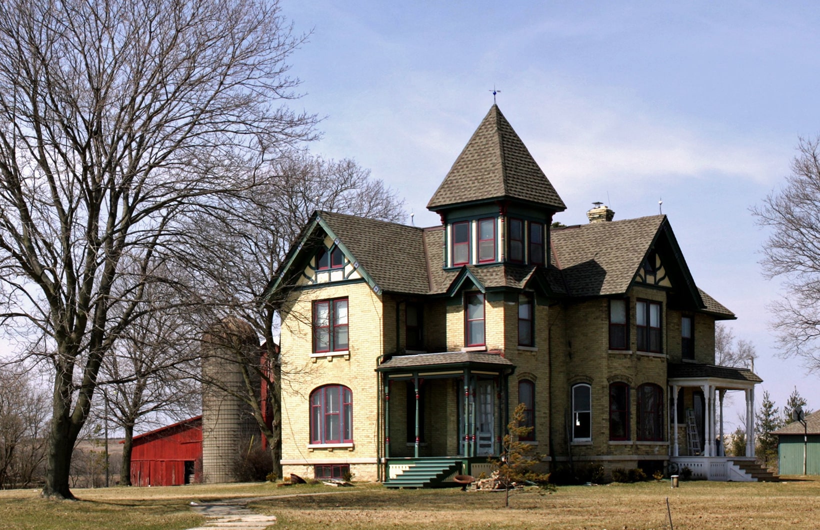 beautiful-shot-big-farmhouse-clear-blue-sky-min